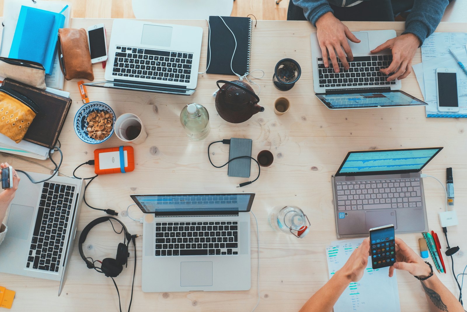 Team at a digital marketing agency in Surat working together on laptops in a modern workspace.